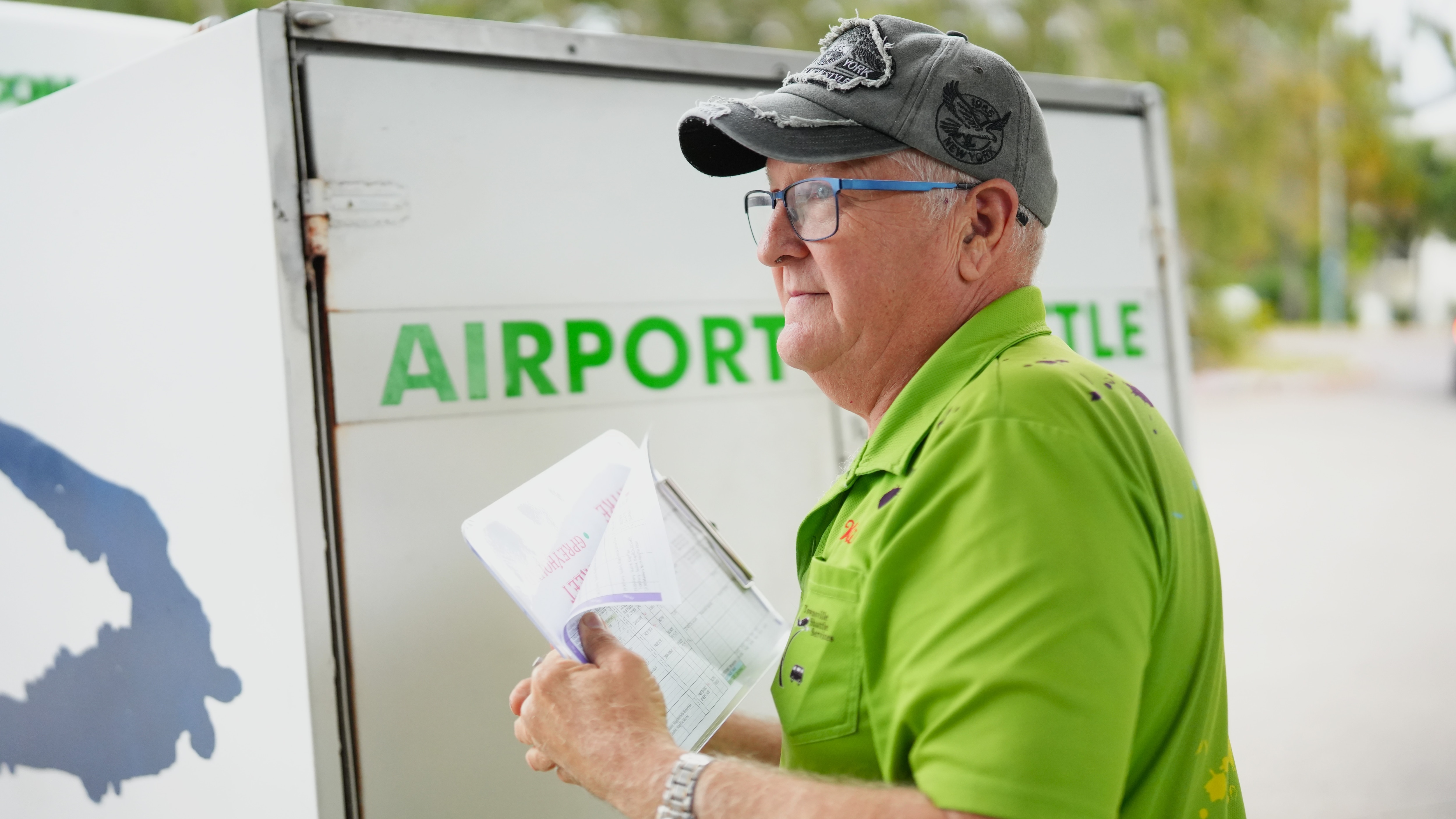 A middle-aged man in a bright green polo shirt.