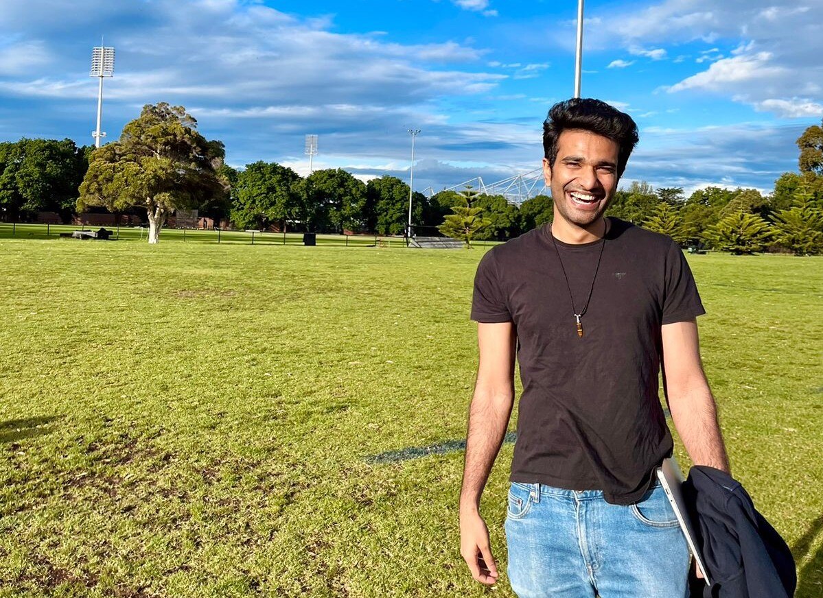  a man wearing black shirt smiling widely to the camera