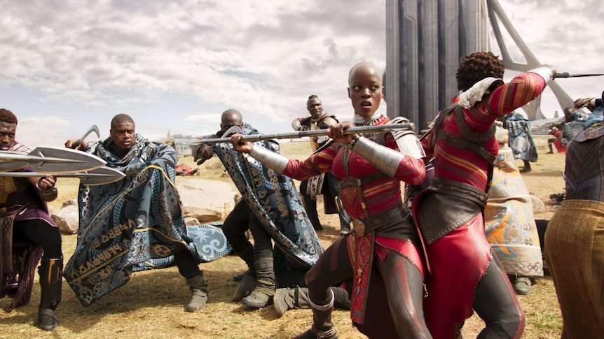 Still image from 2018 film Black Panther of Florence Kasumba and Lupita Nyong'o surrounded by enemies.