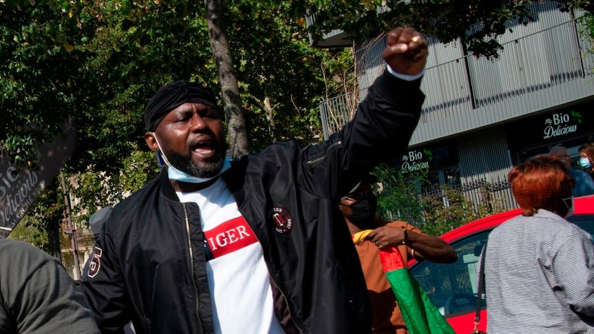 man holds up fist in black power salute