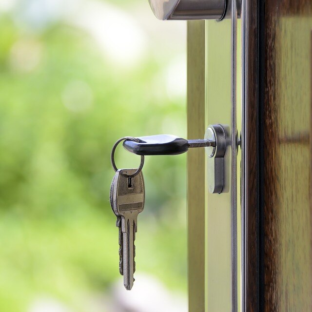 Key in suburban house front door generic image