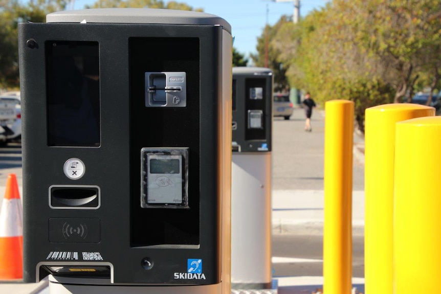 New parking ticket machines installed at Westfield Carousel next to yellow bollards.