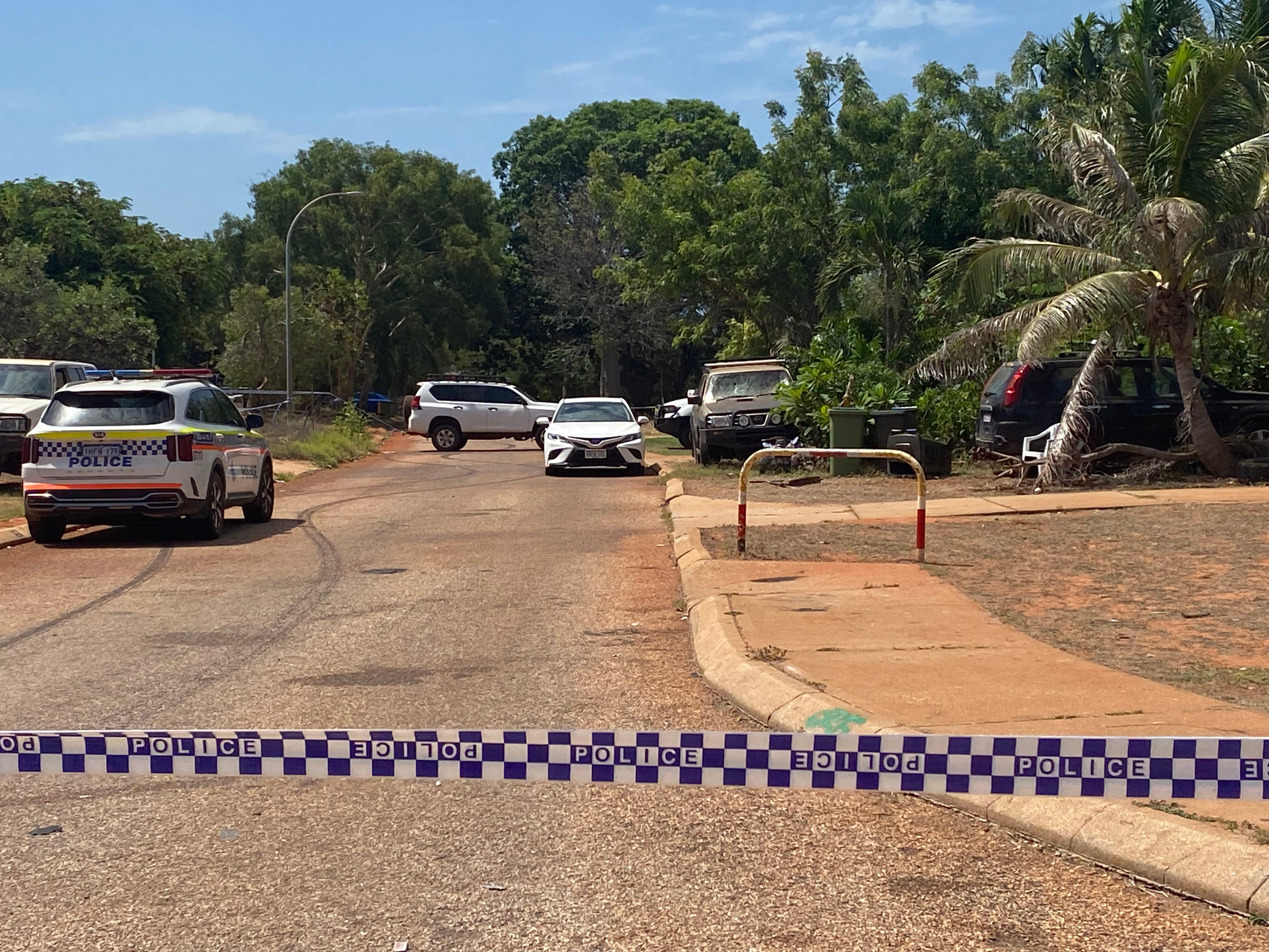 Police tape across a road