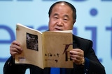2012 Nobel Literature Prizewinner Mo Yan reading a book.