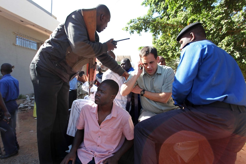 Malian security forces evacuate two people from the Radisson Blu hotel in Bamako.