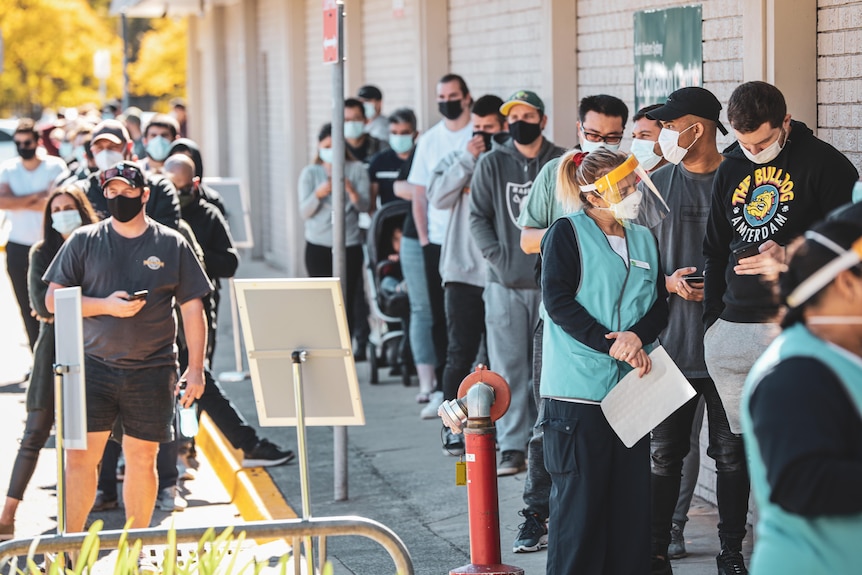 People queue for a COVID jab