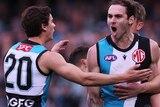 Jeremy Finlayson is grabbed from behind by a teammate as he yells in delight