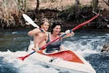 A couple kayaks along a river
