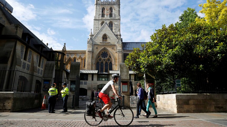 A cyclist rides past London's Southwark cathedral in 2017.