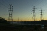 High tension power line towers at dusk