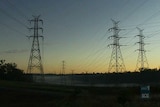 High tension power line towers at dusk