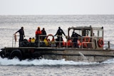 Asylum seekers arrive at Christmas Island after their boat sank off the coast of Indonesia.