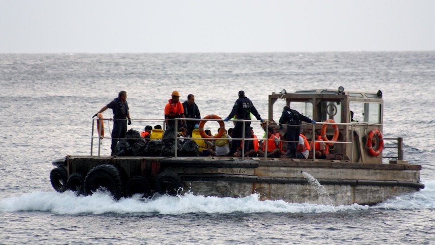 Asylum seekers arrive at Christmas Island after their boat sank off the coast of Indonesia.