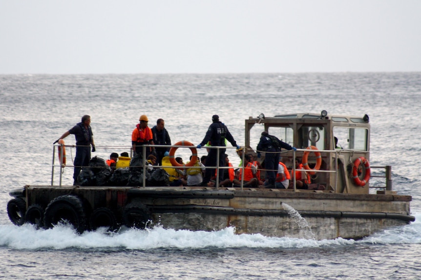 Asylum seekers arrive at Christmas Island after their boat sank off the coast of Indonesia.