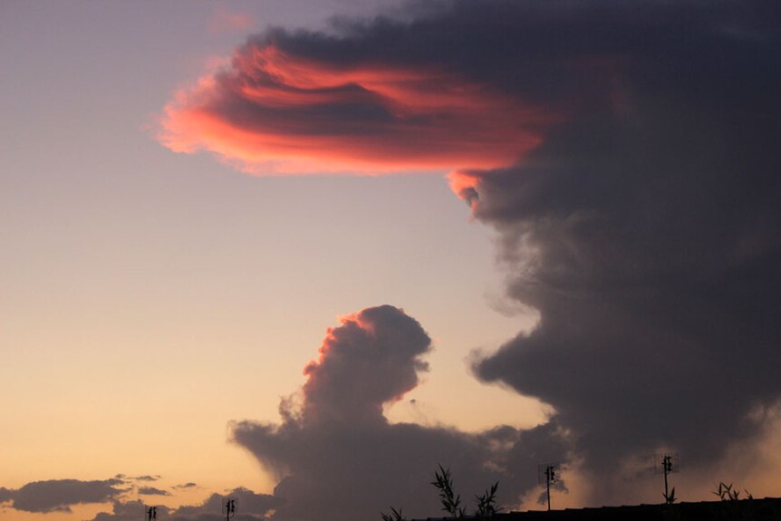 A cloud shaped like Elvis in a stormy sky.