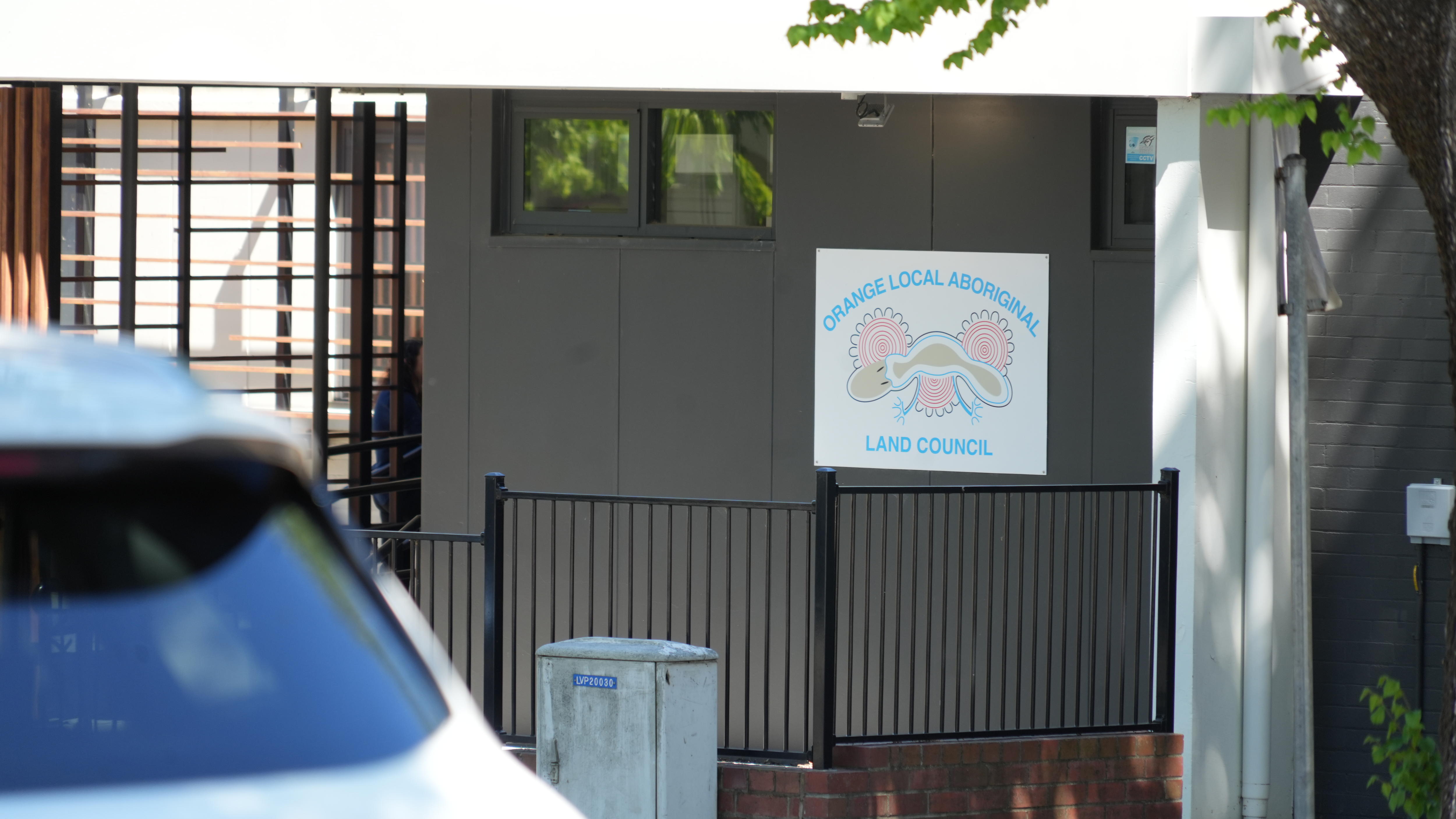picture of street frontage of office, with car in foreground