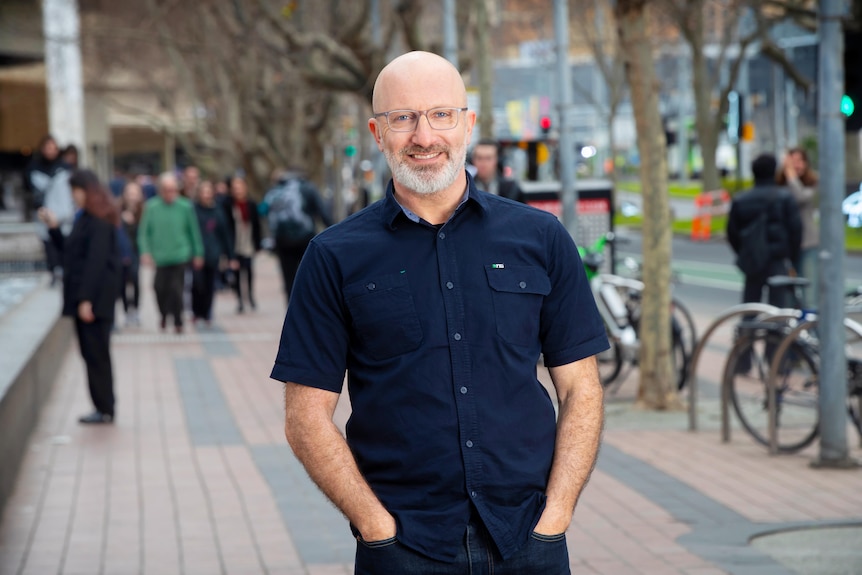 A photo of ABC Radio Melbourne presenter Raf Epstein smiling on a street