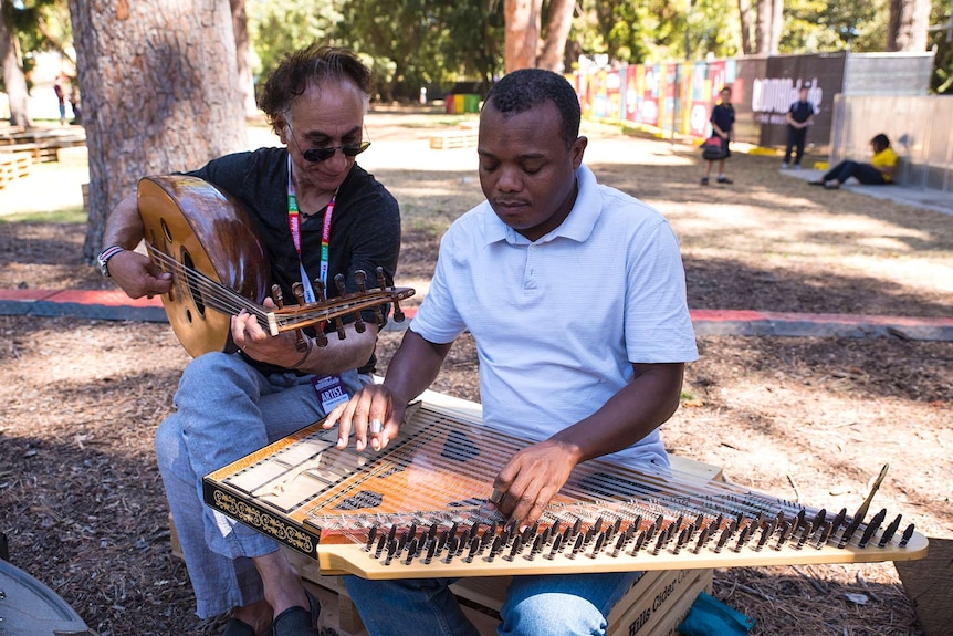 Womadelaide artists Rahim AlHaj and Rajab Suleiman have an impromptu jam.