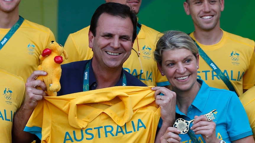 Rio's mayor Eduardo Paes and Kitty Chiller, Australian chef de mission, pose at the Olympic village.