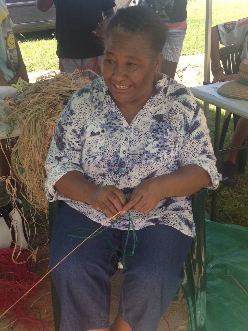 Agnes Fave teaching Palm Island tourists basket weaving