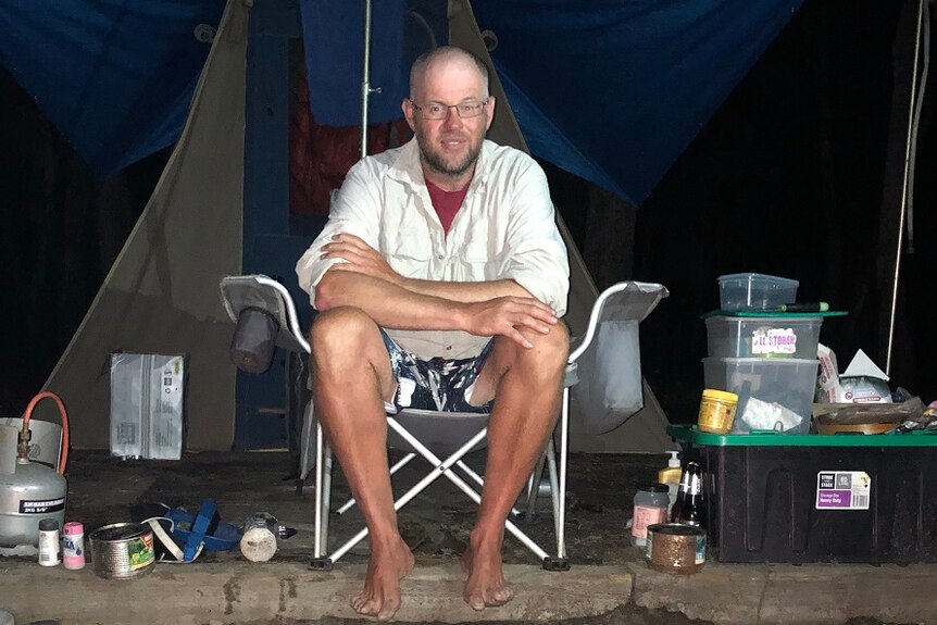 Ski instructor Phil O’Neill sitting in his camp on the Clyde River in NSW.