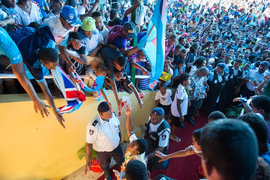 Fans greet Fiji's Olympic gold-medal-winning men's sevens rugby team.