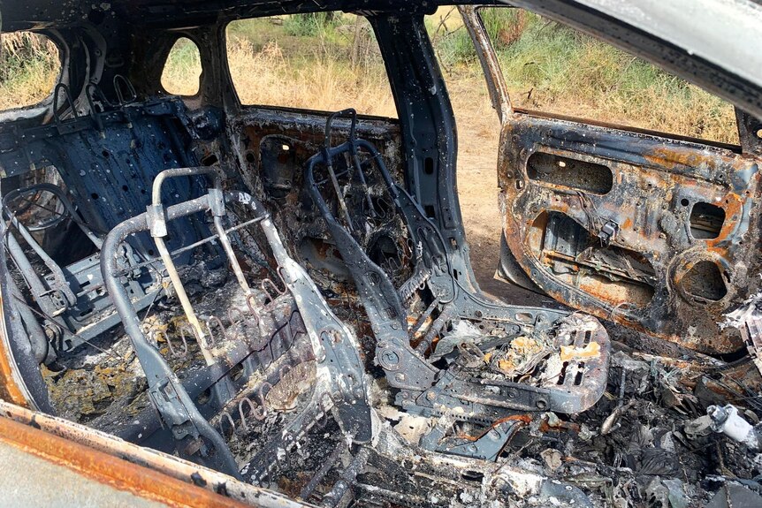 Close-up photo of burnt-out car interior.