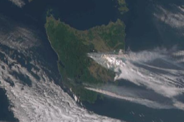 A satellite image of clouds and smoke moving over Tasmania