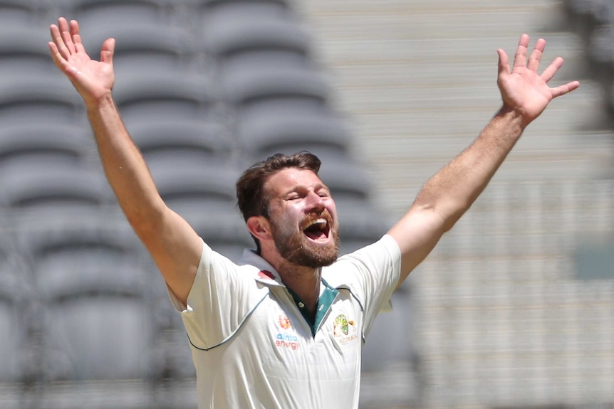 Michael Neser celebrates with arms aloft