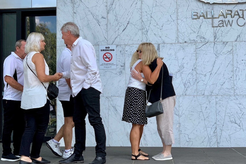 two families hug and shake hands outside the ballarat court house