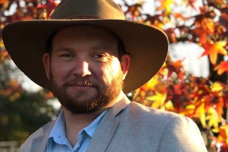 Man standing wearing a hat