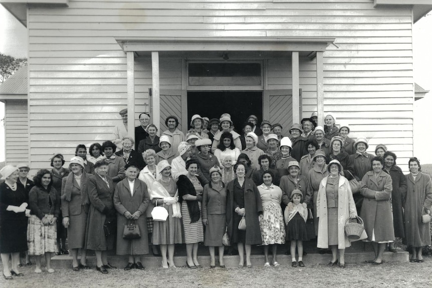 Many women standing posed in black and white picture