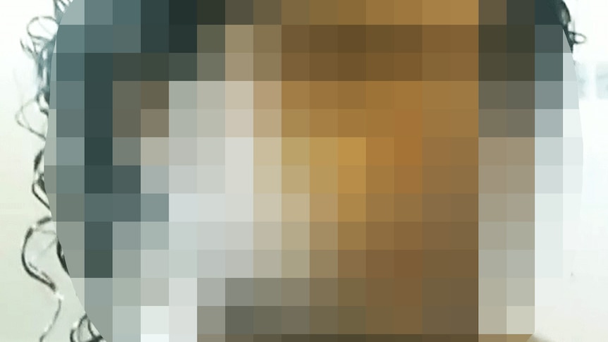 A tight head shot of a heavily pixelated man's face.