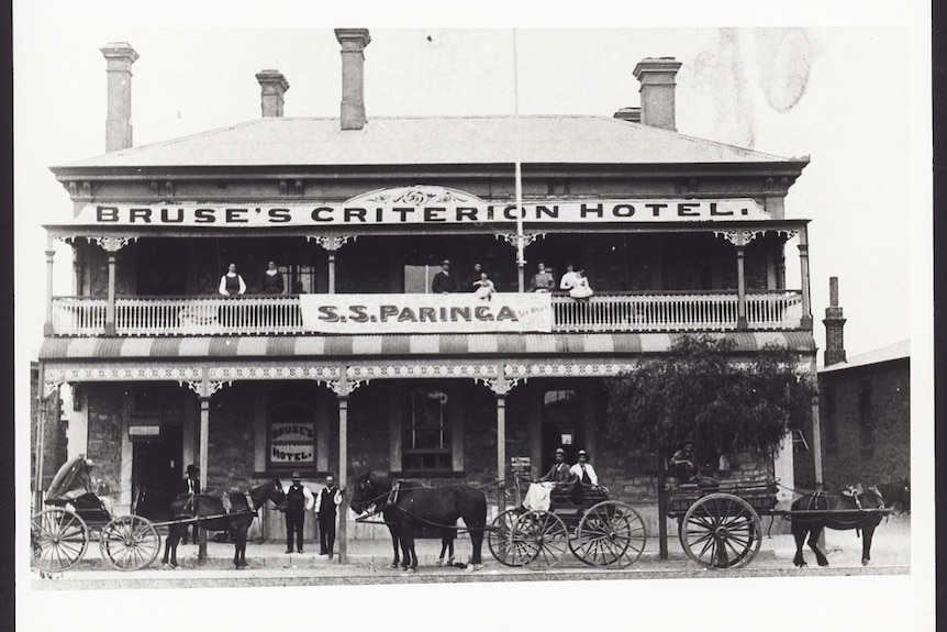 Sepia photograph of old pub with big verandah