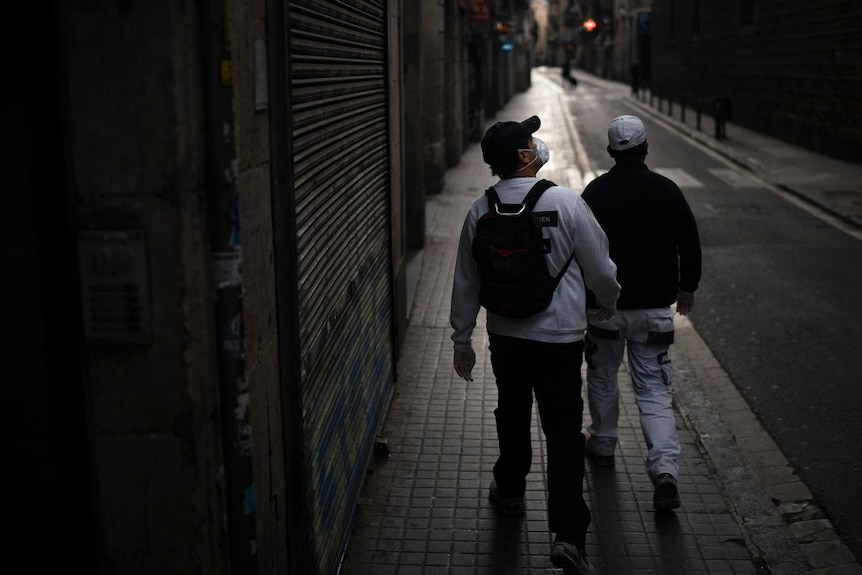 Two men walking through deserted streets.