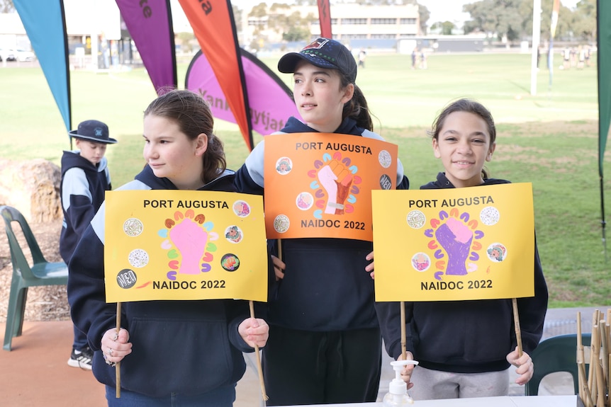 Children holding up posters they made for the 2022 NAIDOC Week march in Port Augusta.  