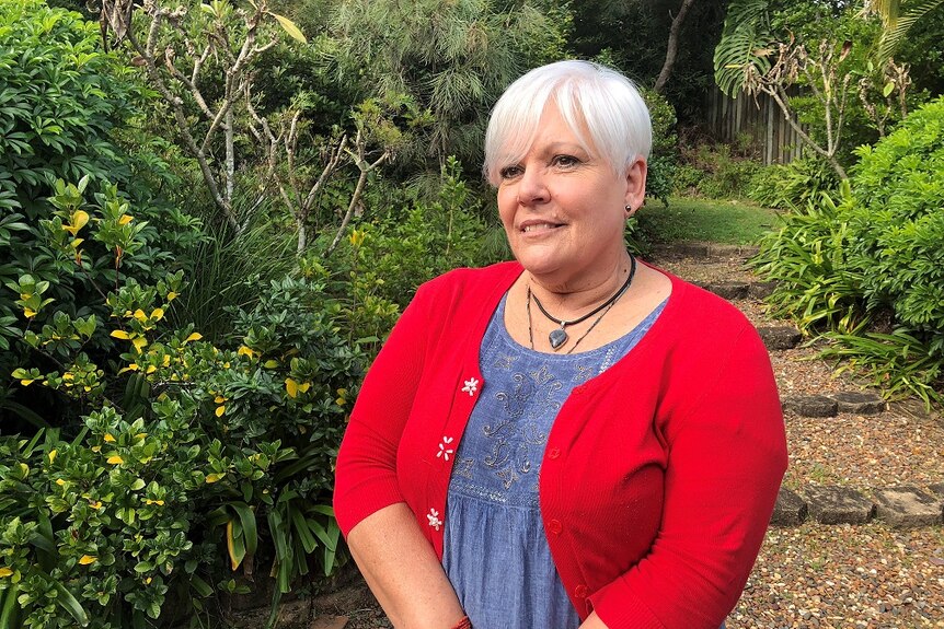 Abuse survivor Diane Lynn standing in her garden.