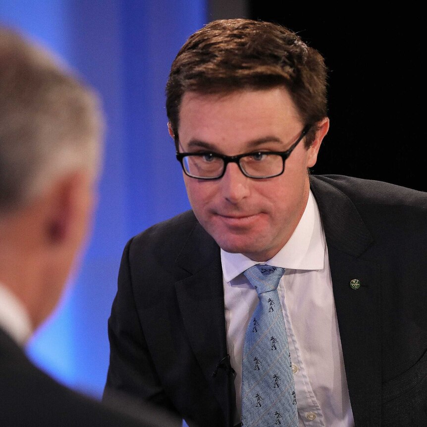 Agriculture Minister David Littleproud during an interview in the ABC's Parliament House Studios, wearing a blue tie and glasses