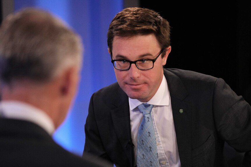 Agriculture Minister David Littleproud during an interview in the ABC's Parliament House Studios, wearing a blue tie and glasses