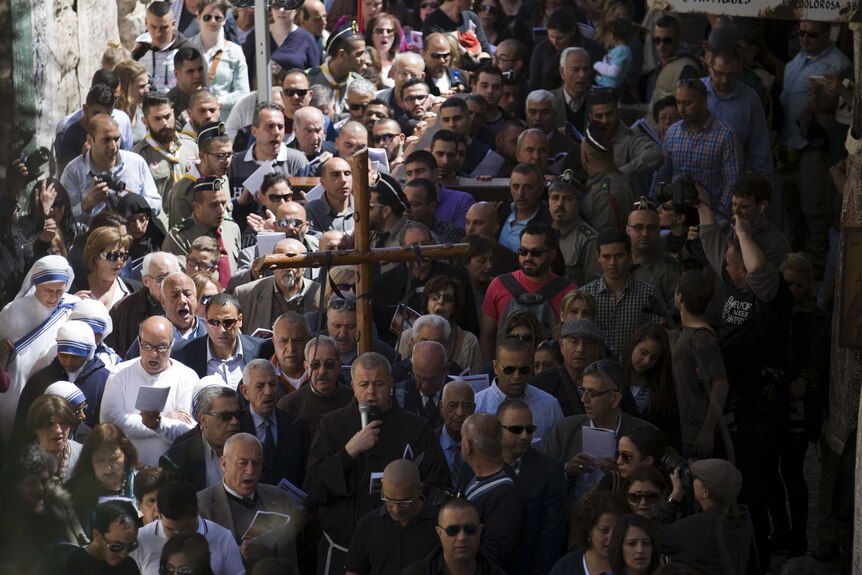 Christians take part in a procession along the Via Dolorosa