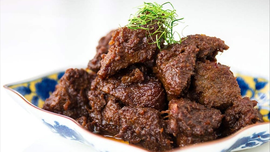 A dish full of beef curry.