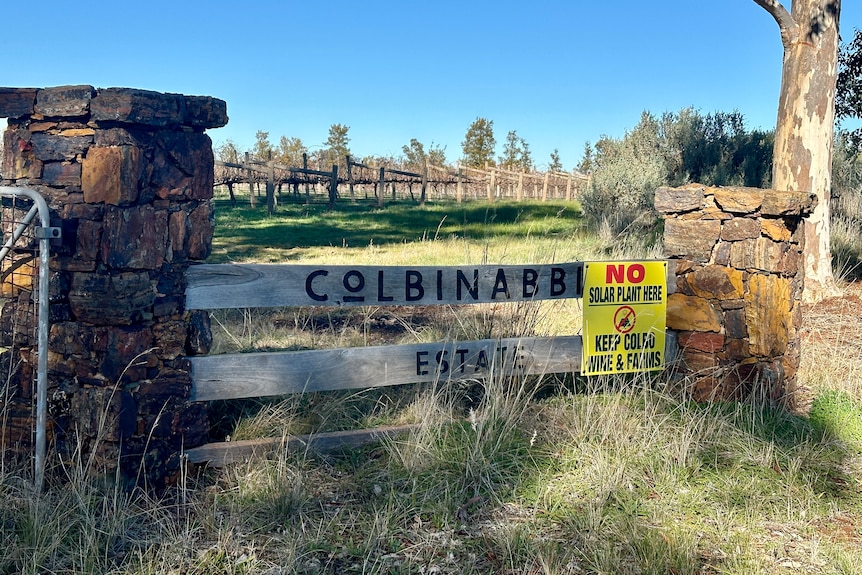 A sign saying 'no solar plant here', on top of a sign for Colbinabbin Estate.