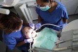 Woman with two dentists