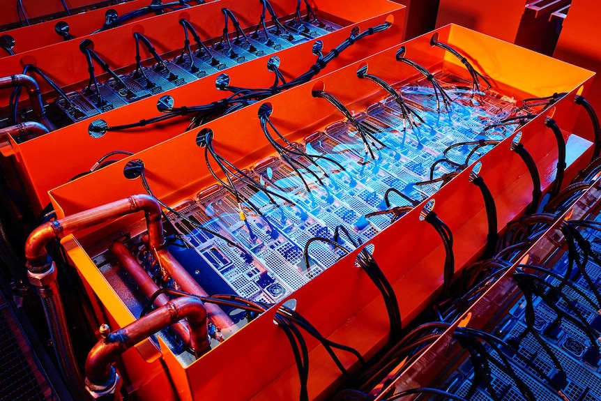 The inside of part of a large, orange-coloured data centre