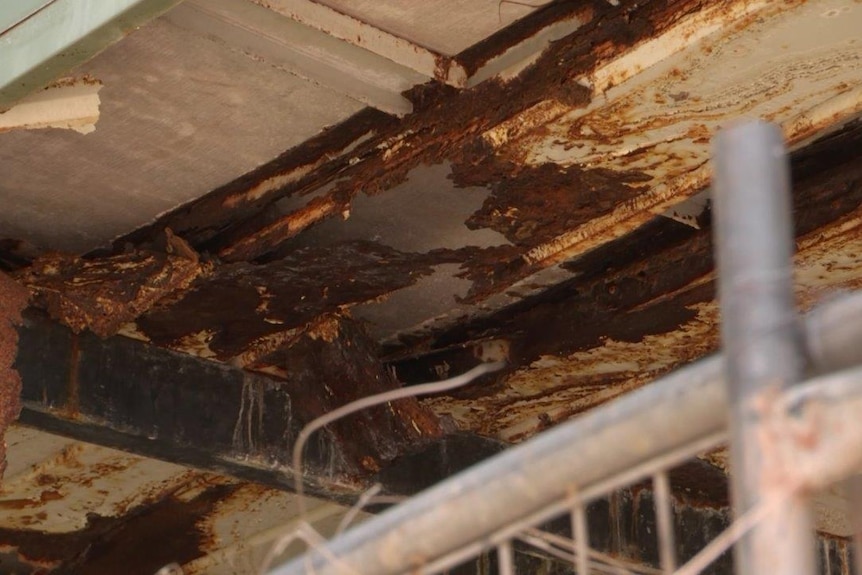 The rusted and dilapidated flooring of a Top End home.