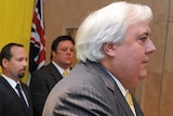 Clive Palmer speaks as Ricky Muir and Glenn Lazarus look on.
