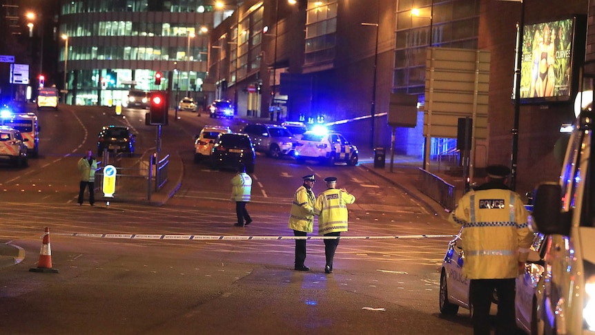 Emergency services work at Manchester Arena after reports of an explosion at the venue