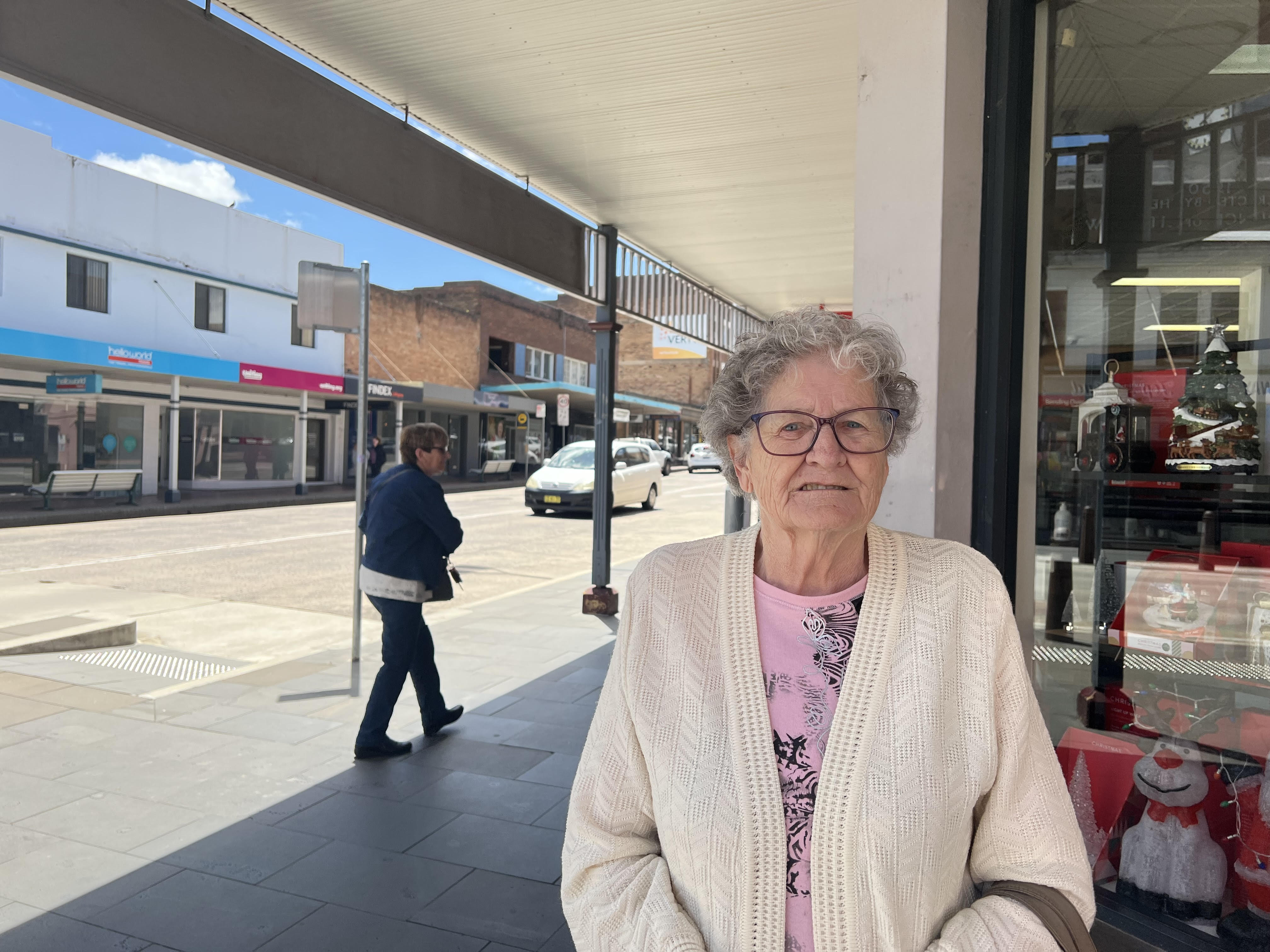 Retired housewife Jill Fitzgerald looks into camera as she stands on the sunny main street of Lithgow