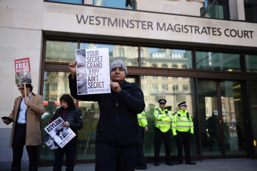 A protester demonstrates in support of WikiLeaks founder Julian Assange outside Westminster magistrates court
