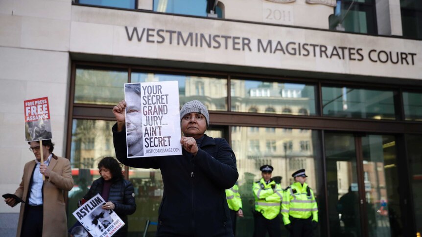 A protester demonstrates in support of WikiLeaks founder Julian Assange outside Westminster magistrates court